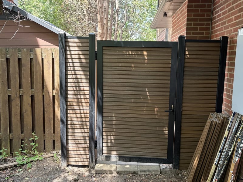 Composite privacy fence installation in Natural Brown — Natural Brown