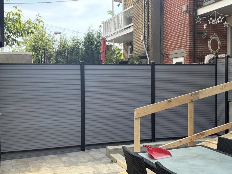 Composite privacy fence installation in Stone Grey — Stone Grey