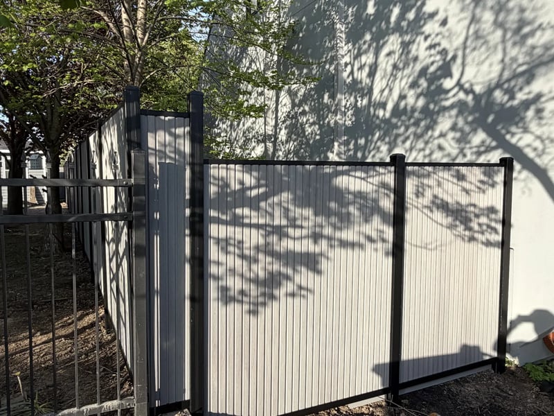 Composite privacy fence installation in Stone Grey — Stone Grey