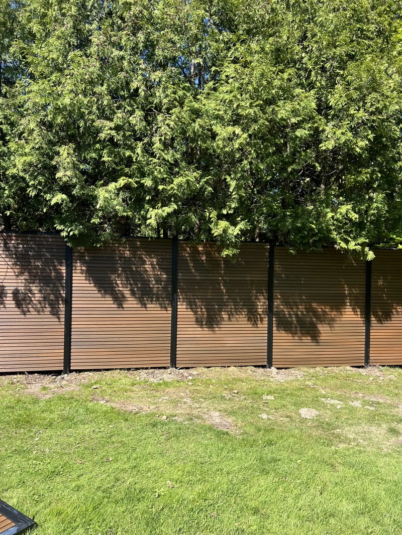 Composite privacy fence installation in Natural Brown — Natural Brown